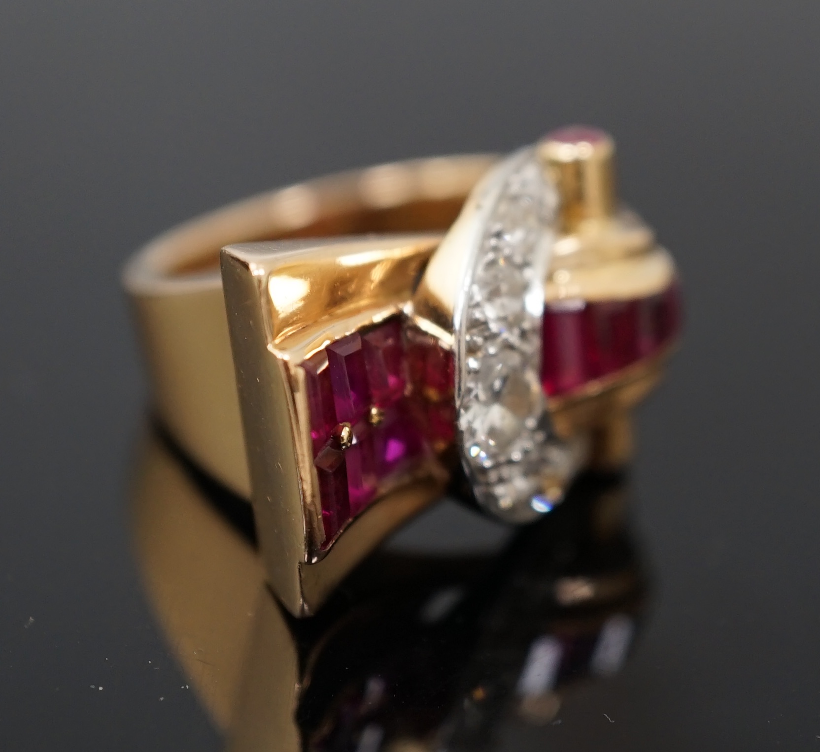 A 1950's continental gold, synthetic ruby, round and rose cut diamond cluster set fan shaped 'buckle' cocktail ring